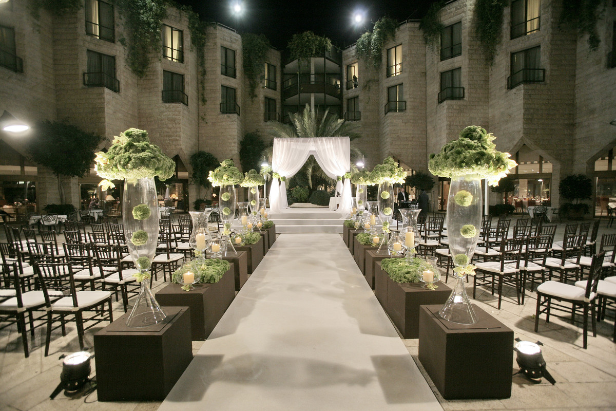 Bring a sense of grandeur with tall floor vases aligned with the aisle runner